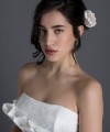 Bride wearing the Letizia strapless ball gown wedding dress in ivory duchess satin with corset lace-up back, handmade in London