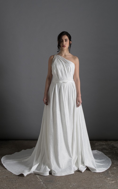 Bride wearing the Lorenza one-shoulder ballgown wedding dress with crystal strap and train, ivory, handmade in London