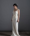 Bride wearing the Lia wedding dress in ivory satin with a detachable tulle overskirt and lace-trimmed train, handmade in London