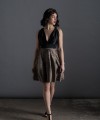 Valeria short halter cocktail dress with deep V-neck black satin bodice, open back and black and beige pleated jacquard skirt