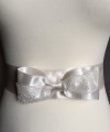 Ivory satin bridal sash belt with a satin and lace bow and silver-edged trim