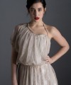 Bride wearing the Lucia one-sleeve vintage-inspired wedding dress in stone lace with pearl and crystal belt, handmade in London