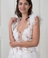 Nadia boho A-line wedding dress covered in 3D fabric flowers with a deep V nude illusion bodice