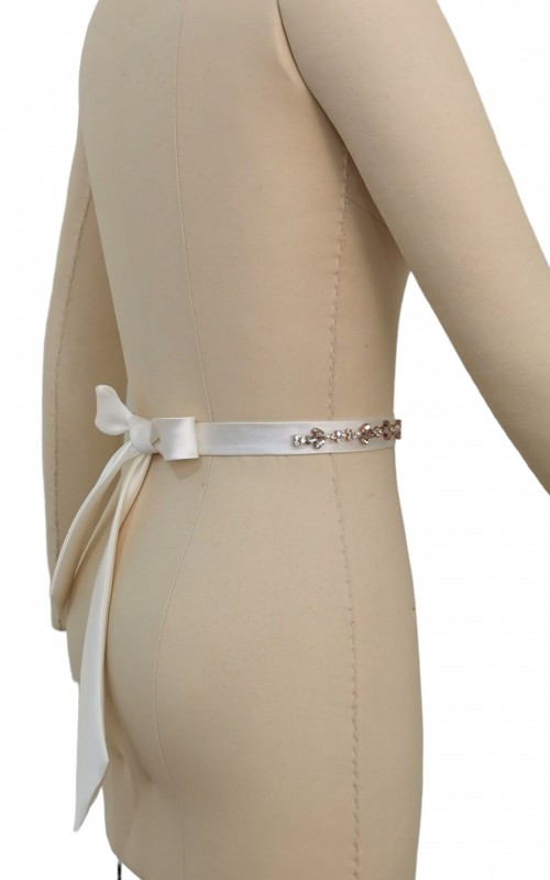 Bridal sash belt with a rose gold crystal and pearl appliqué that ties at the back in a bow