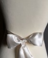 Ivory satin bridal sash belt with a satin and lace bow and silver-edged trim