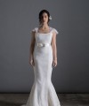 Bride wearing the Laura mermaid wedding dress in ivory duchess satin with white Italian lace and chapel train, handmade in London