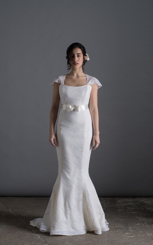 Bride wearing the Laura mermaid wedding dress in ivory duchess satin with white Italian lace and chapel train, handmade in London