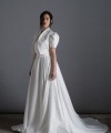 Bride wearing the Lorenza one-shoulder ballgown wedding dress with crystal strap and train, ivory, handmade in London