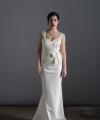 Bride wearing the Lia wedding dress in ivory satin with a detachable tulle overskirt and lace-trimmed train, handmade in London
