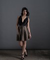 Valeria short halter cocktail dress with deep V-neck black satin bodice, open back and black and beige pleated jacquard skirt