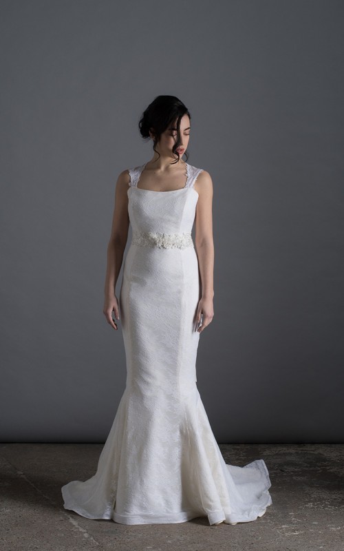 Bride wearing the Laura mermaid wedding dress in ivory duchess satin with white Italian lace and chapel train, handmade in London