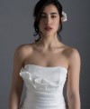 Bride wearing the Letizia strapless ball gown wedding dress in ivory duchess satin with corset lace-up back, handmade in London