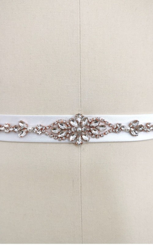 Bridal sash belt with a rose gold crystal and pearl appliqué that ties at the back in a bow