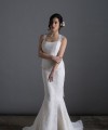 Bride wearing the Laura mermaid wedding dress in ivory duchess satin with white Italian lace and chapel train, handmade in London