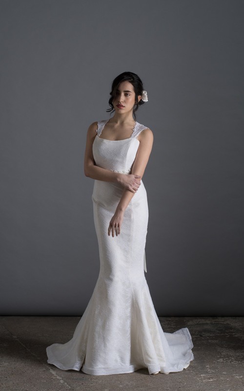 Bride wearing the Laura mermaid wedding dress in ivory duchess satin with white Italian lace and chapel train, handmade in London