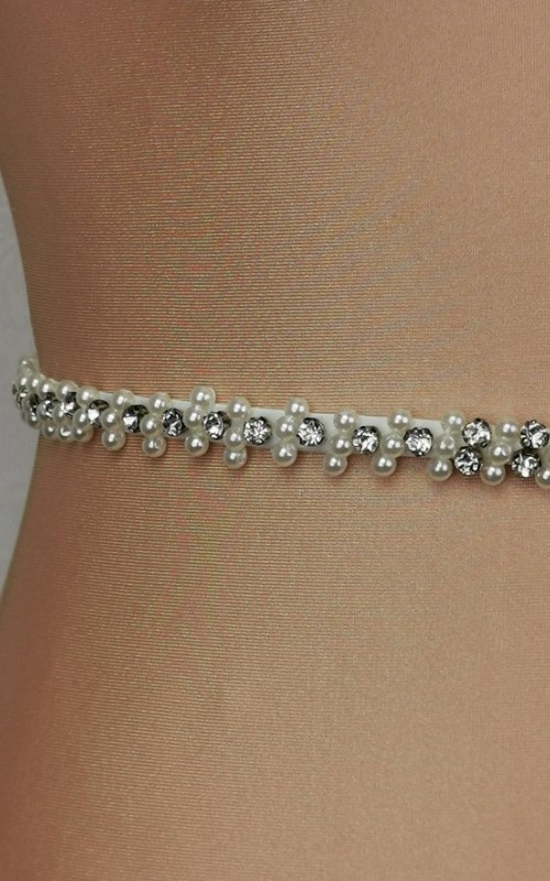 Slim ivory bridal belt covered in hand-sewn crystals and pearls with a covered-button back