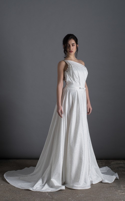 Bride wearing the Lorenza one-shoulder ballgown wedding dress with crystal strap and train, ivory, handmade in London