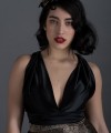 Valeria short halter cocktail dress with deep V-neck black satin bodice, open back and black and beige pleated jacquard skirt