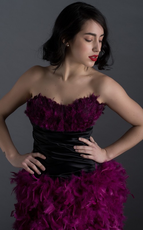Virginia short black duchess satin cocktail dress with sweetheart neckline and purple plum feathers