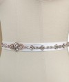Bridal sash belt with a rose gold crystal and pearl appliqué that ties at the back in a bow