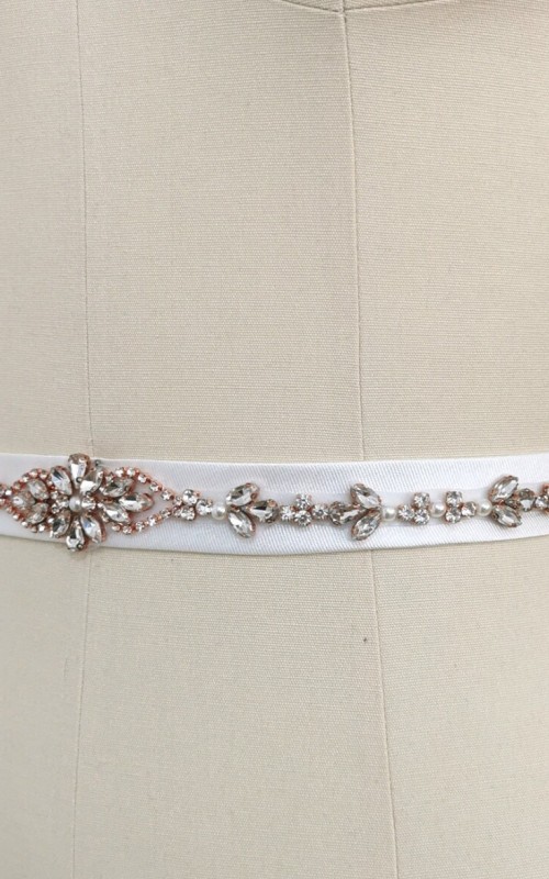 Bridal sash belt with a rose gold crystal and pearl appliqué that ties at the back in a bow